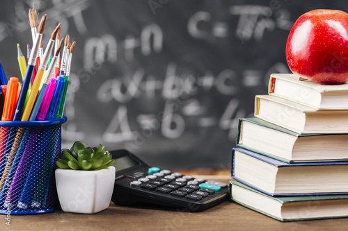 Books and stationery at teacher desk