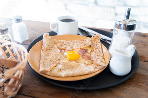 French breakfast featuring a crêpe with an egg and coffee © Petteri
