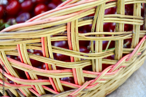 Fresh ripe cherries in wicker basket 