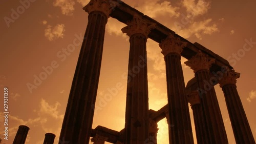 Cinematic sunset shot of the beautiful Roman Temple of Evora, or Temple of Diana, a significant landmark dating to 1st century AD. Enclosed by medieval walls, Evora is a UNESCO World Heritage