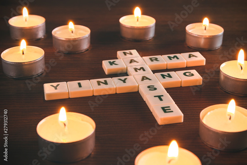 Namaste, Karma and Yin Yang words surrounded by candles