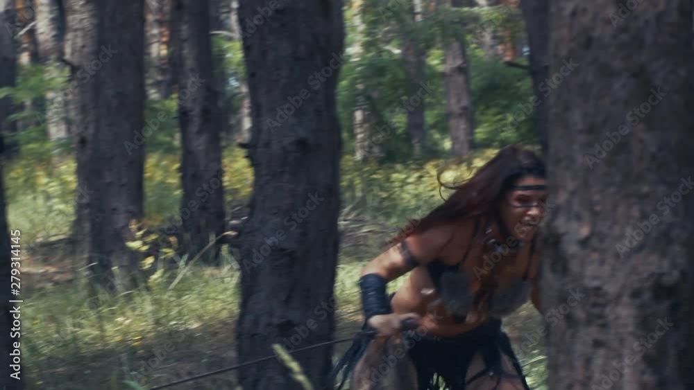 Running amazon woman in leather and fur clothes in slow motion Running amazon woman in leather and fur clothes in slow motion