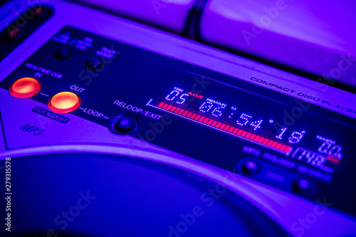 Closeup of digital LED time display on a CD Player. Blue stage lighting.