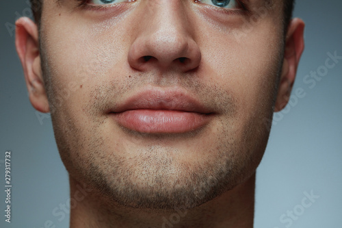 Fényképezés Close-up portrait of young man isolated on grey studio background
