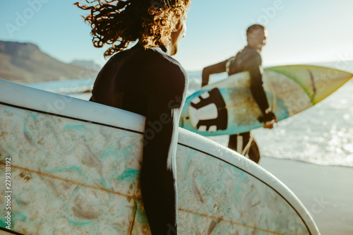 Surfers going for surfing in the sea photo