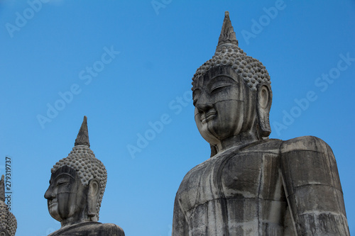 Buddha face in blue sky background  Buddha statue in Thailand.