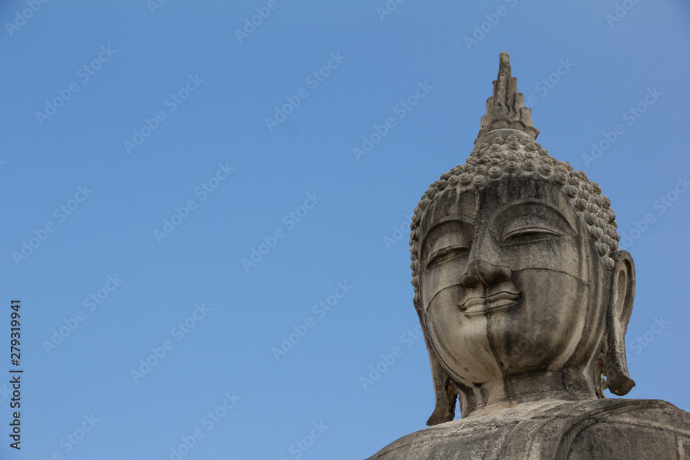 Buddha face in blue sky background, Buddha statue in Thailand. Buddha face in blue sky background, Buddha statue in Thailand.