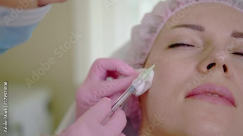 Woman getting treatment with injectable hyaluronic acid dermal filler