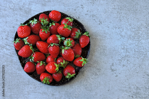 Fresh juicy strawberries on a plate.