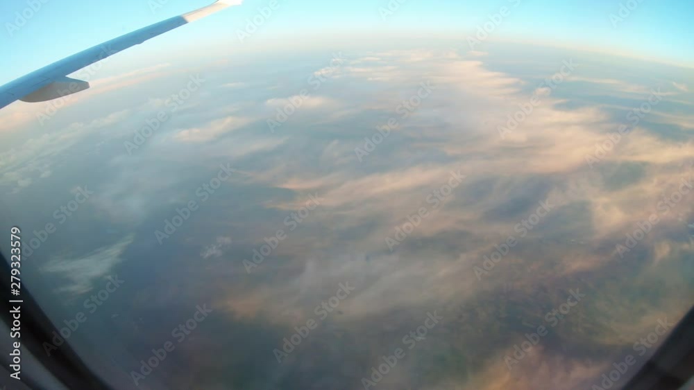 Porthole window view. The continent of Europe under clouds. Porthole window view. The continent of Europe under clouds.