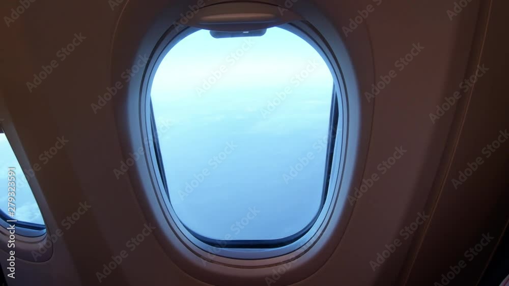 Man Opens Plane Porthole Window Man Opens Plane Porthole Window