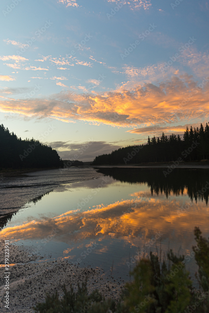 Fototapeta premium sunset over lake crazy orange sky
