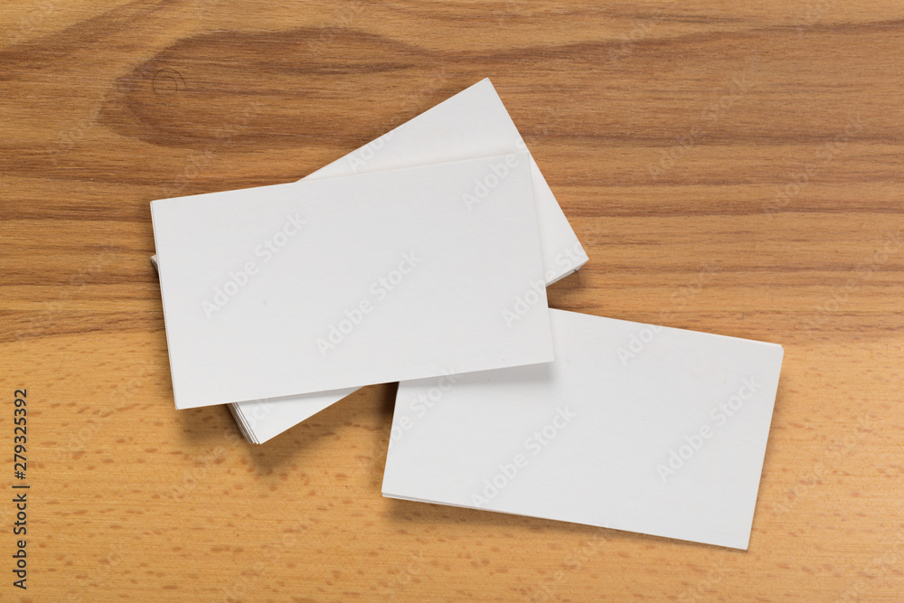 Mockup of business cards stack at wooden background. Design concept. Template for branding identity. Mockup of business cards stack at wooden background. Design concept. Template for branding identity.