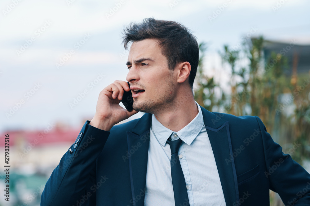 business man talking on the phone on the street business man talking on the phone on the street