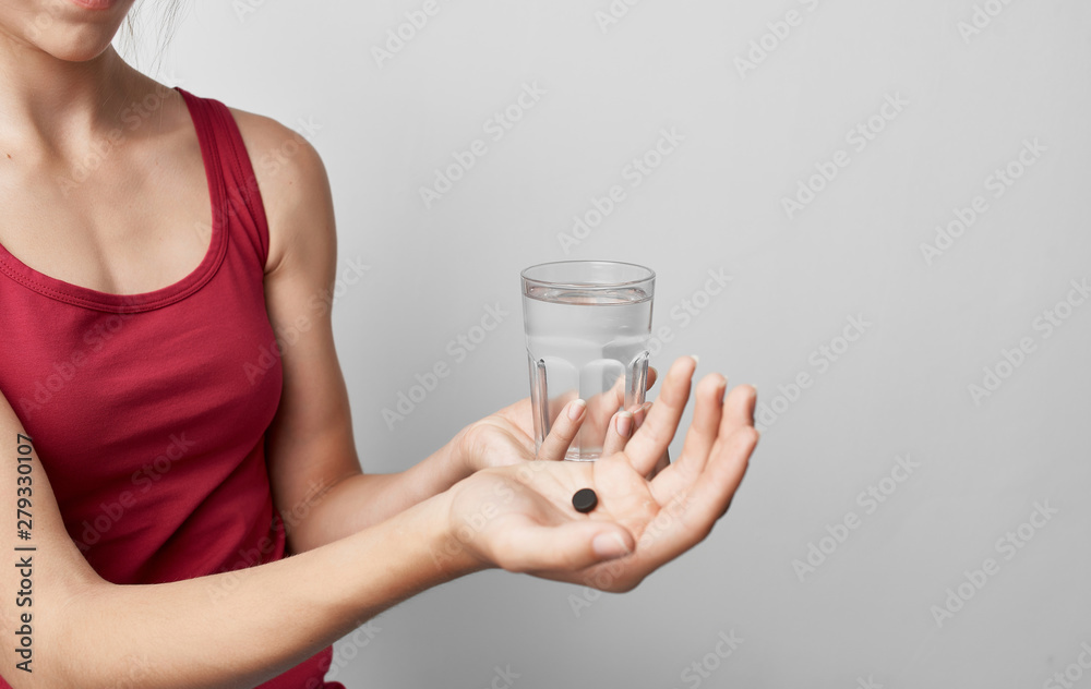 woman holds in her hand a glass of water tablet woman holds in her hand a glass of water tablet