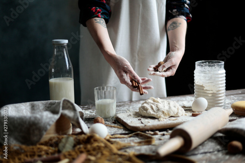 Woman making dough. woman with ingredients for dough. baking and cooking concept rustic style photo for cook book and cook blog. Christmas cookies baking with cinnamon