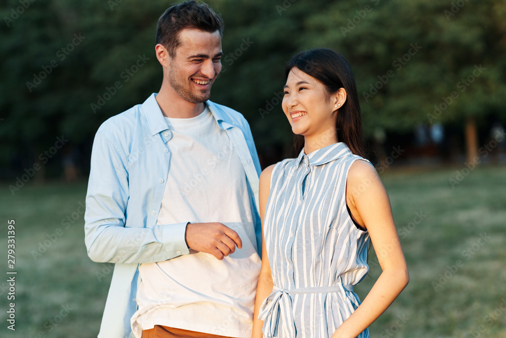 happy young couple walking in the park happy young couple walking in the park