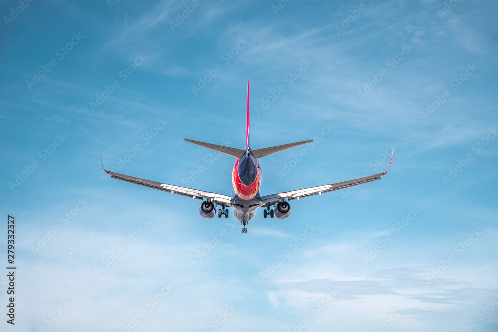 Obraz premium Aviation, travel, air transportation concept. Airplane in blue sky