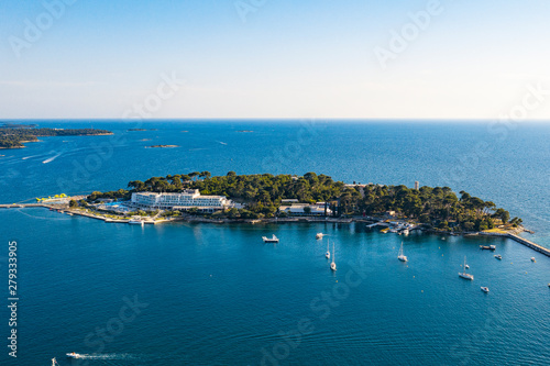 Aerial view of costal town. Aerial seaside buildings view. Aerial photo of the seashore buildings with green trees and small islands.
