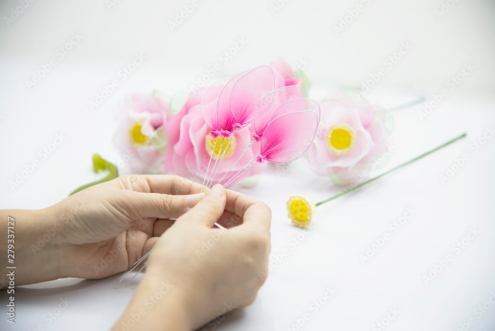 Woman making beautiful nylon flower - people with DIY handmade flower concept Woman making beautiful nylon flower - people with DIY handmade flower concept