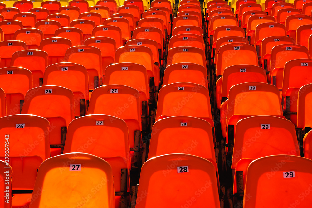 bright orange rows of seats in the stadium bright orange rows of seats in the stadium