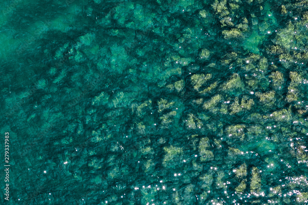 Aerial view of rocky seaside. Rocky stones in the ocean. Aerial photography of beautiful rocky seashore.