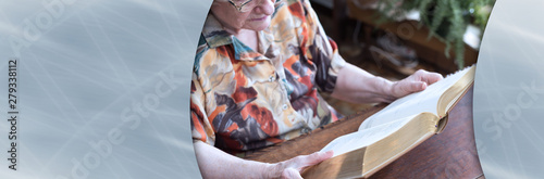 Old woman reading a book; panoramic banner