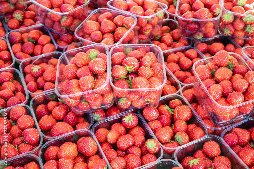 Strawberries in plastic containers at farmers market, background, texture. Strawberries in plastic containers at farmers market, background, texture.