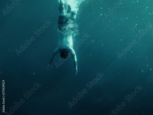 Man falling into the water. Underwater shot. Vacation, sports and active lifestyle risk concept. © TeamDF