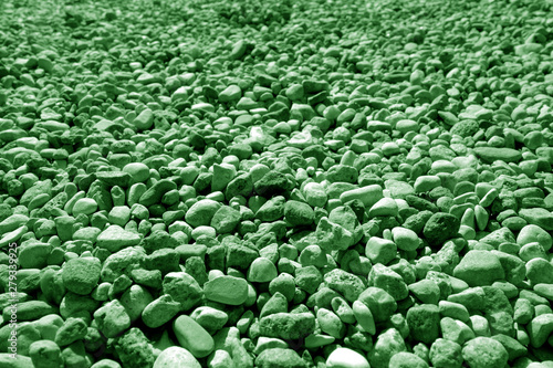 Pile of small gravel stones in green tone.