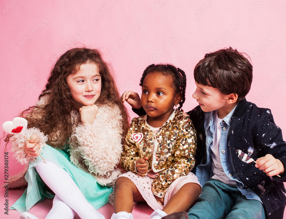 lifestyle people concept: diverse nation children playing together, boy and girl, caucasian and african american