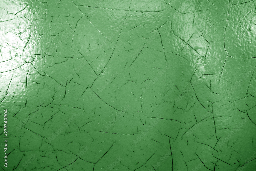 Cracked paint texture in green color.