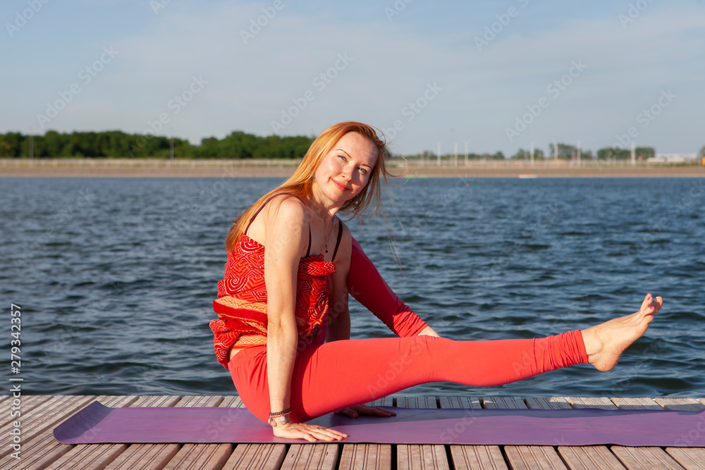 Young woman practicing yoga in the nature.