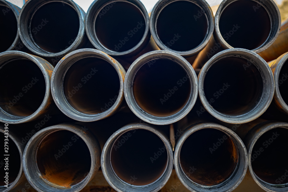 Steel Pipes bunch on the rack in warehouse. Iron pipes at shelf in warehouse. Steel Pipes bunch on the rack in warehouse. Iron pipes at shelf in warehouse.