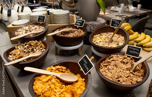 Selection of self service catering continental breakfast buffet display, catering or brunch table food buffet filled with all sorts of delicious food, cereal display in a hotel or restaurant setting photo