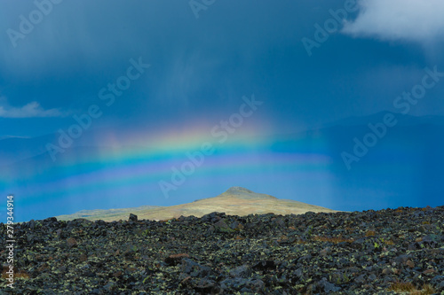 Rainbow on Norway's most beautiful mountain trek across the Besseggen ridge, Jotunheimen National Park, Norway