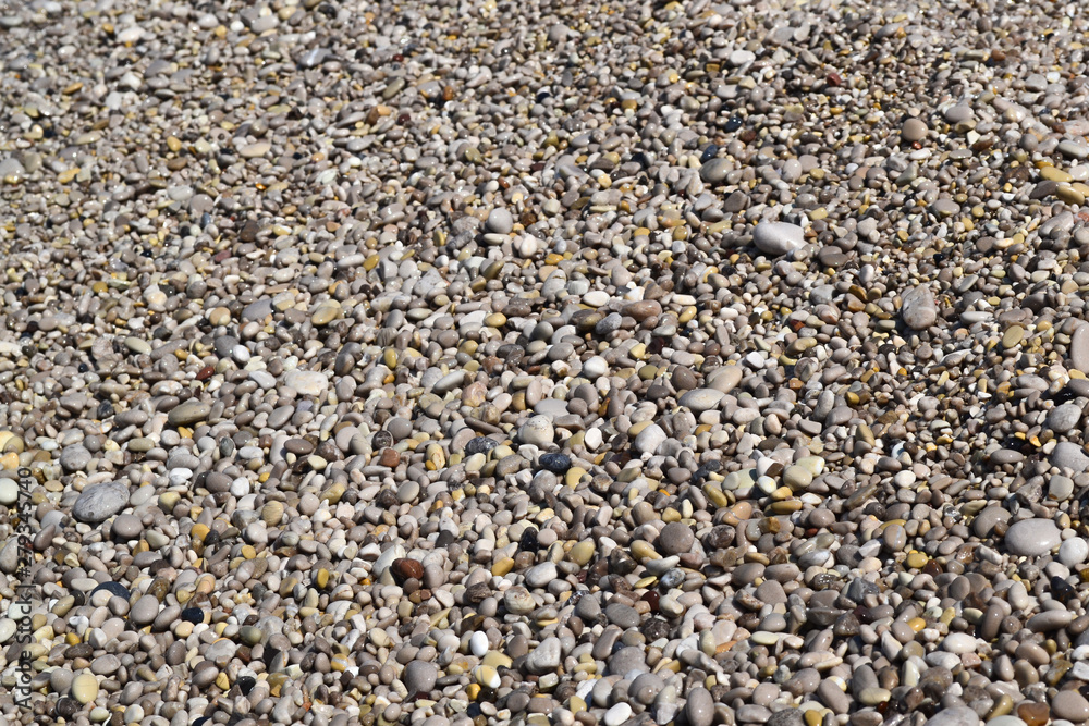 Texture of many multicolored beautiful round and oval smooth natural stones, pebbles. The background. Texture of many multicolored beautiful round and oval smooth natural stones, pebbles. The background.