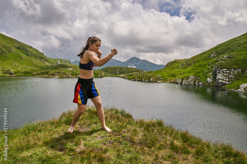 Woman kickbox fighter training by the lake © Xalanx