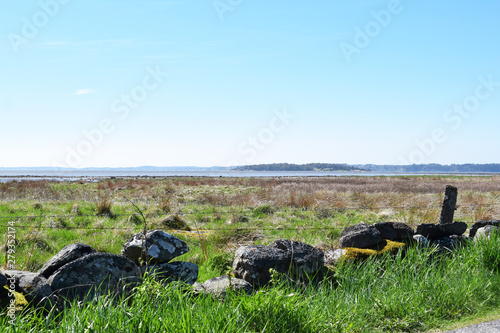 Stone wall, field and ocean