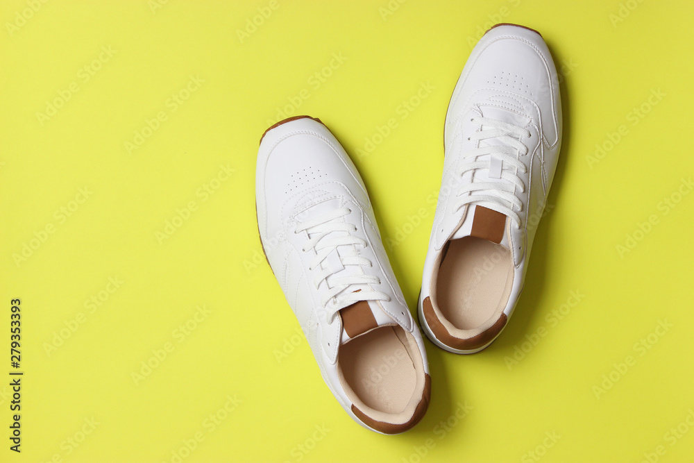men's sneakers on a colored background top view. men's footwear. minimalism men's sneakers on a colored background top view. men's footwear. minimalism