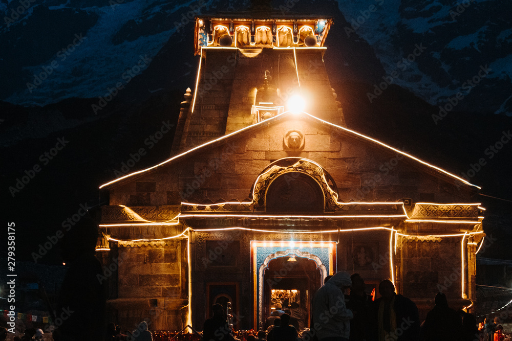 View of the Kedarnath temple lights at night with mountains in the