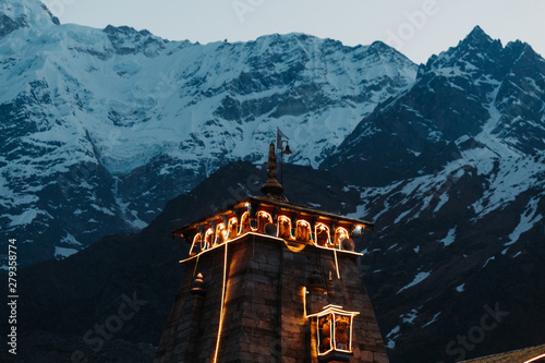 View of the top of the Kedarnath Temple with mountains in the background photo