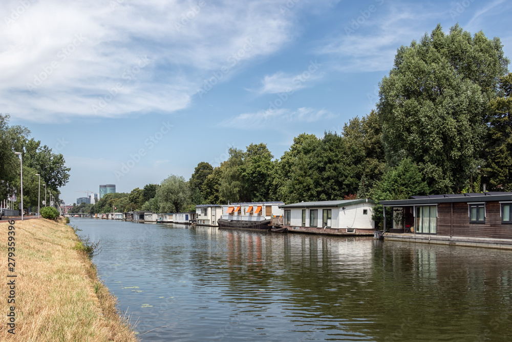Dutch canal in city Utrecht with moored houseboats Dutch canal in city Utrecht with moored houseboats