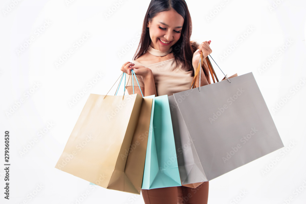 The blurry light design background of beautiful woman holding shopping bags in hand,twith smile and happy feeling,the shopaholic lady, The blurry light design background of beautiful woman holding shopping bags in hand,twith smile and happy feeling,the shopaholic lady,