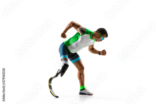 Athlete with disabilities or amputee isolated on white studio background. Professional male runner with leg prosthesis training and practicing in studio. Disabled sport and healthy lifestyle concept.