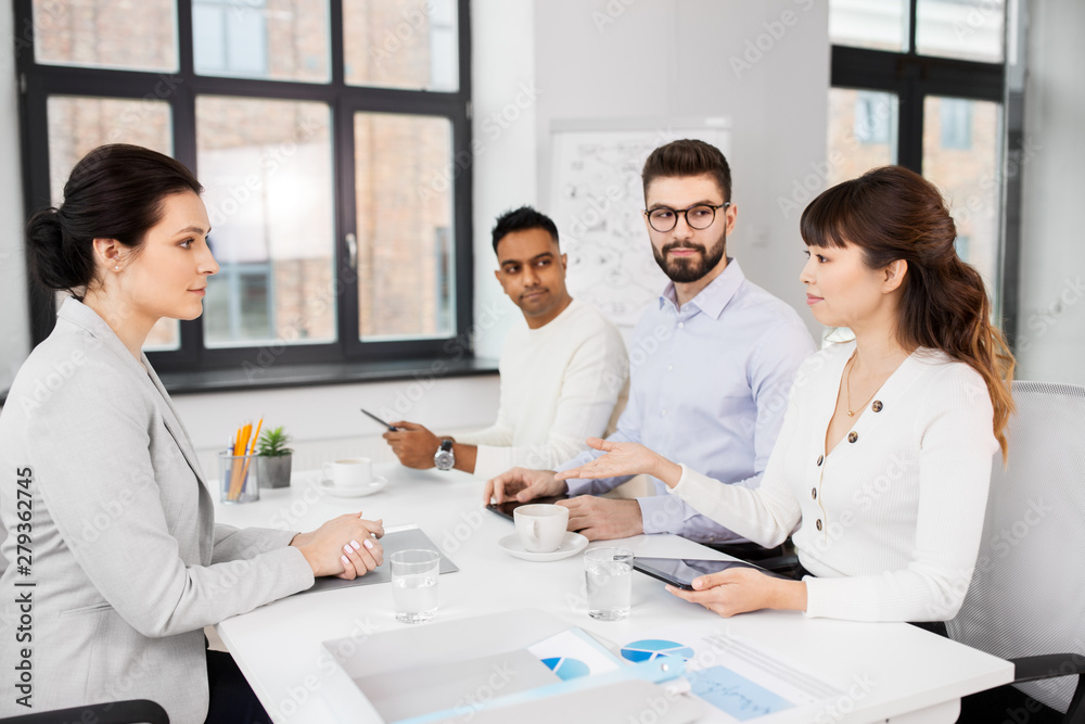 Fototapeta premium new job, hiring and employment concept - international team of recruiters having interview with female employee at office