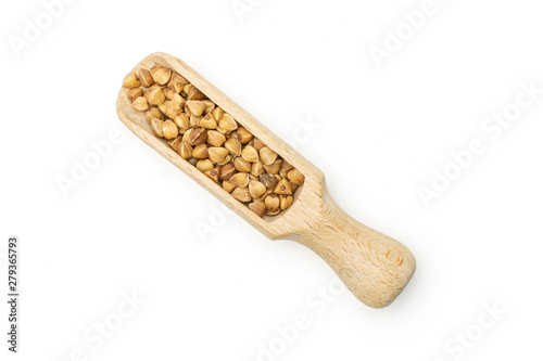 Lot of whole raw brown buckwheat grain with wooden scoop flatlay isolated on white background