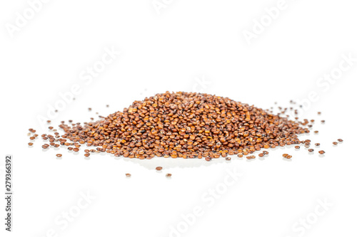 Lot of whole raw red quinoa seeds heap isolated on white background