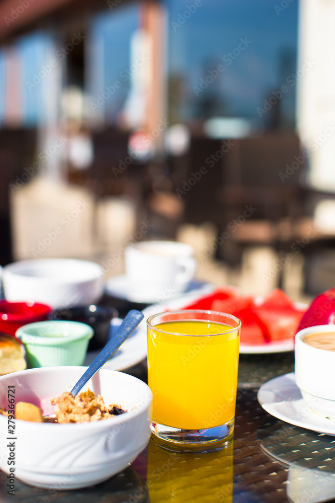Cacao, juice, muesli and fruits for breakfast at a cafe in the resort