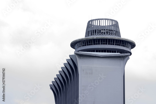 Modern building with circular roof deck isolated. Tall building with clear blue sky